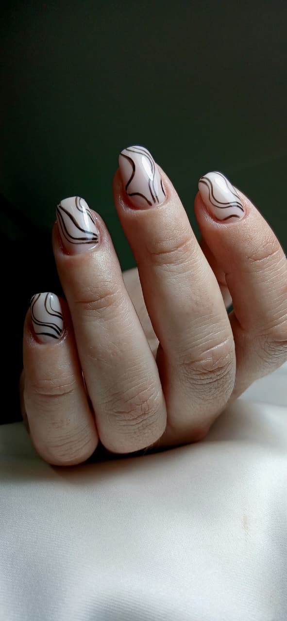 Nude manicure with flowing black line art